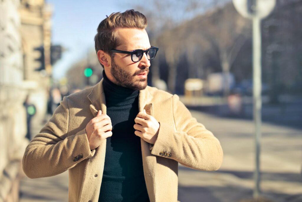 man wearing eyeglasses and brown jacket